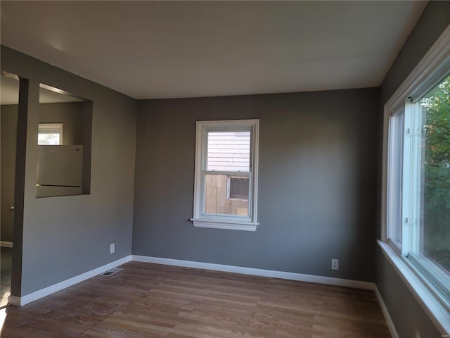 empty room with hardwood / wood-style flooring