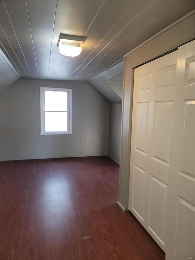 bonus room featuring dark hardwood / wood-style floors and vaulted ceiling