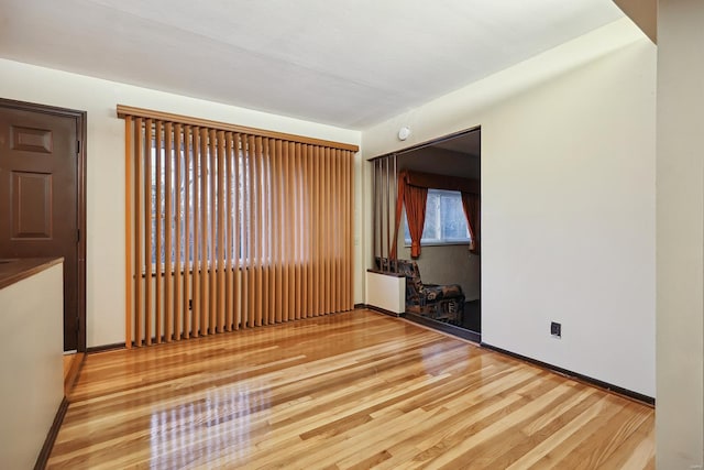 empty room with hardwood / wood-style floors