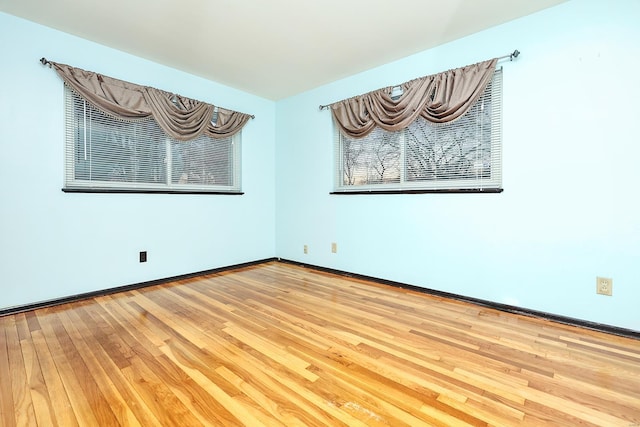 spare room with hardwood / wood-style flooring