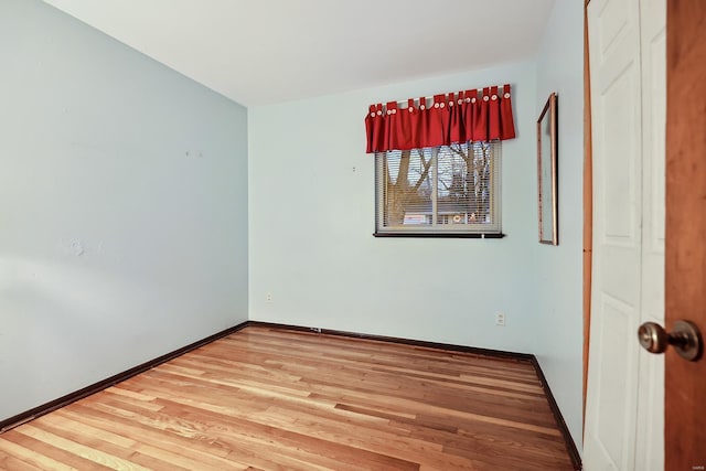 spare room with hardwood / wood-style floors