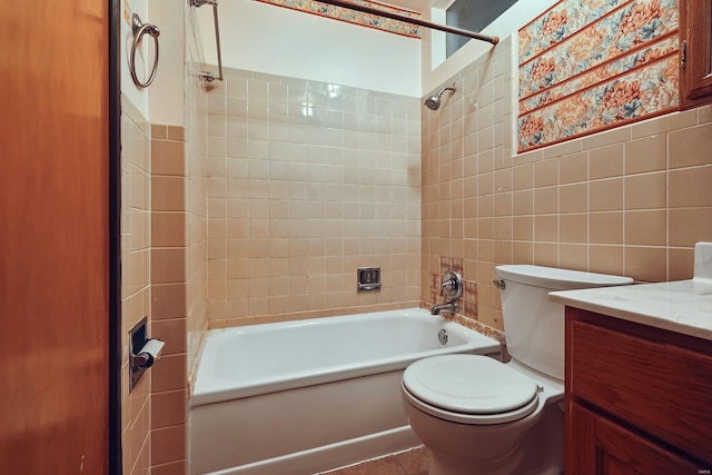 full bathroom with vanity, toilet, tile walls, and tiled shower / bath combo