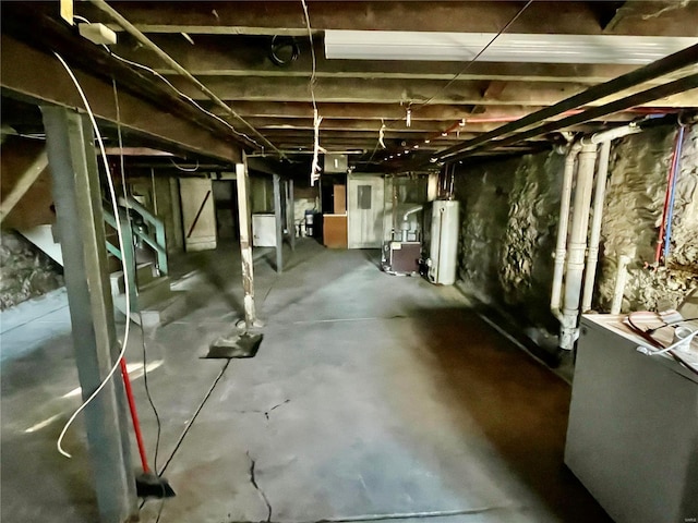 basement featuring washer / clothes dryer and water heater