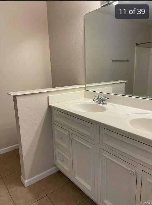 bathroom featuring tile patterned flooring and vanity