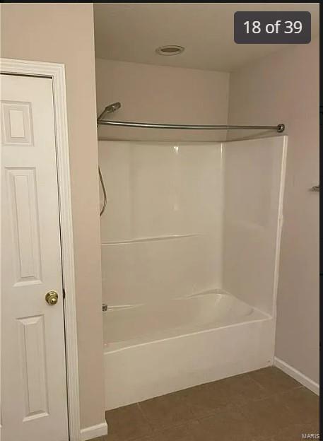 bathroom with tile patterned flooring and  shower combination