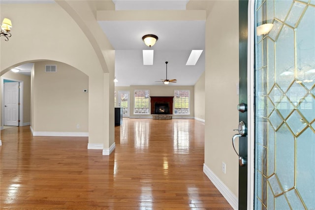 foyer entrance with ceiling fan and hardwood / wood-style flooring