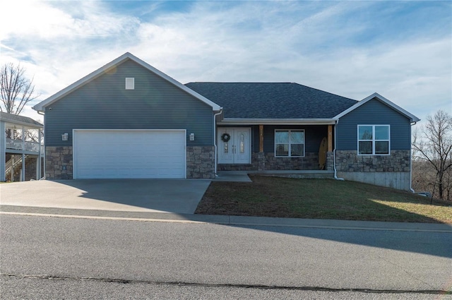 view of front of home featuring a garage and a front lawn