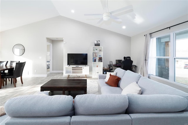 living room with plenty of natural light, ceiling fan, lofted ceiling, and light hardwood / wood-style flooring