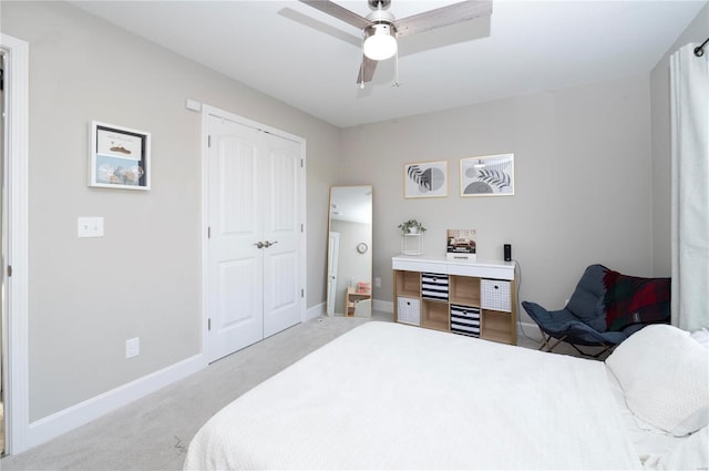 carpeted bedroom featuring ceiling fan and a closet