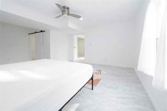 bedroom featuring a barn door and ceiling fan