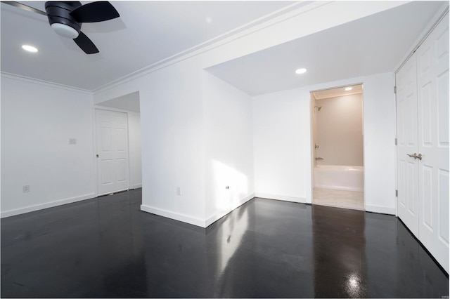 spare room featuring ceiling fan and crown molding