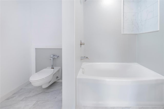 bathroom featuring a washtub and toilet