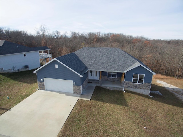 view of front of home with a porch, a garage, and a front lawn