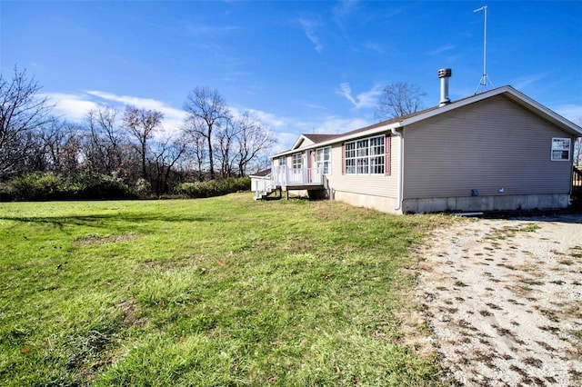 view of side of home featuring a lawn