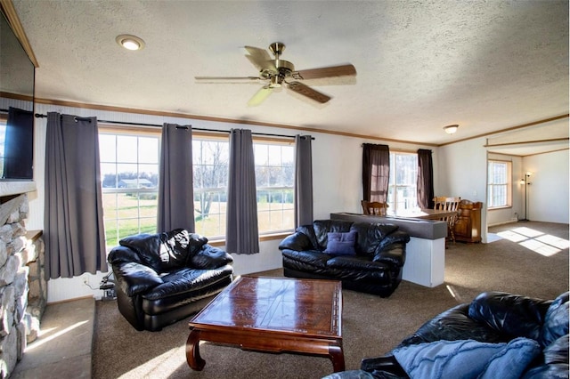 living room with a wealth of natural light, light colored carpet, and a textured ceiling