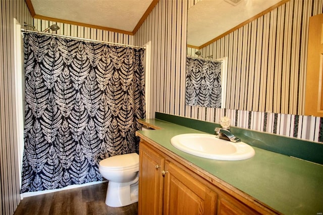 bathroom featuring vanity, a textured ceiling, crown molding, wood-type flooring, and toilet