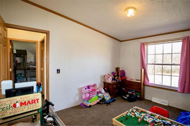 rec room featuring a textured ceiling, carpet floors, and ornamental molding