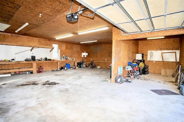 garage featuring a workshop area and a garage door opener