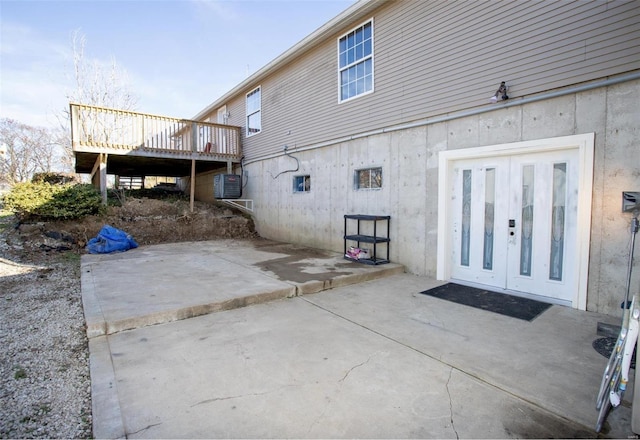 rear view of house featuring a patio area, french doors, and a deck