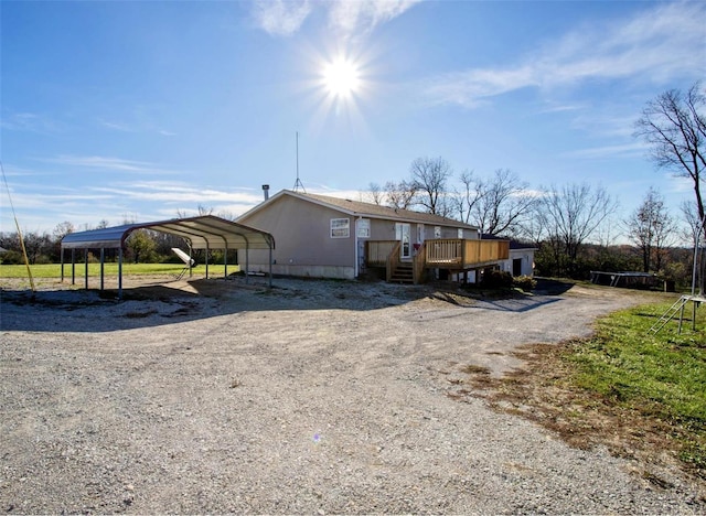 exterior space with a carport and a deck