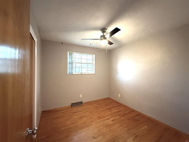 empty room featuring wood-type flooring and ceiling fan