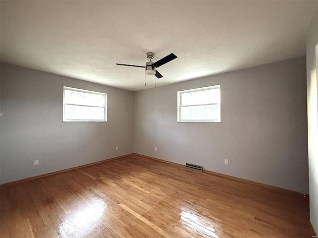 unfurnished room featuring light hardwood / wood-style floors and a healthy amount of sunlight