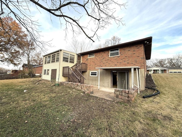 rear view of house featuring a yard