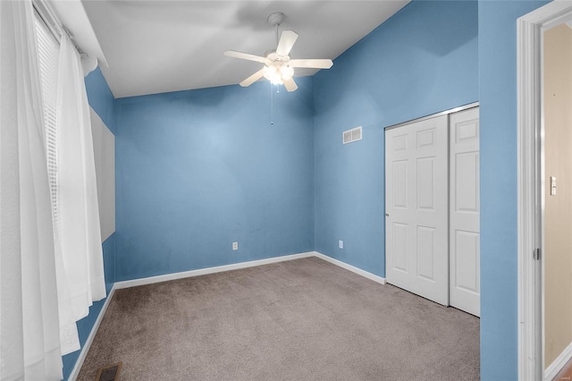 unfurnished bedroom with ceiling fan, a closet, and light carpet