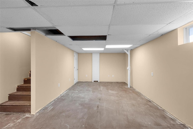 basement with a paneled ceiling