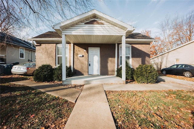 view of front of home with covered porch and stucco siding