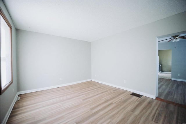 empty room featuring hardwood / wood-style floors and ceiling fan