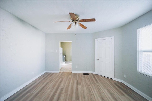 empty room featuring ceiling fan and light wood-type flooring