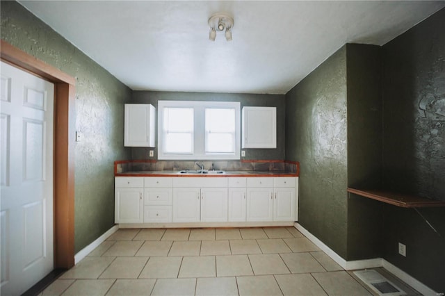 kitchen with white cabinetry and sink