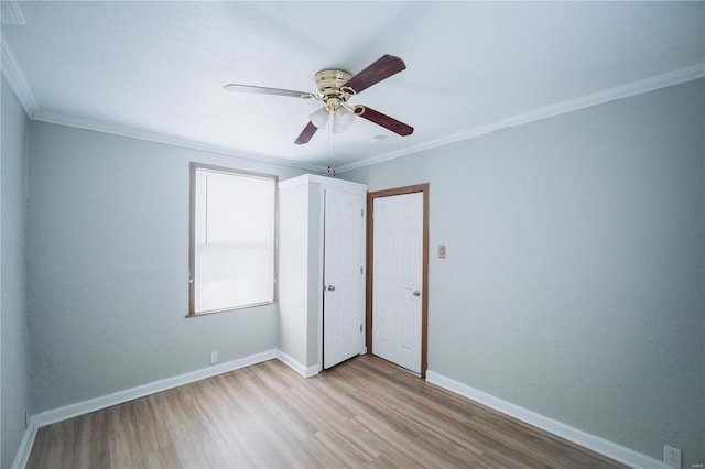 unfurnished bedroom featuring light hardwood / wood-style flooring, ceiling fan, and ornamental molding