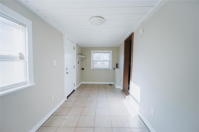 clothes washing area featuring light tile patterned floors