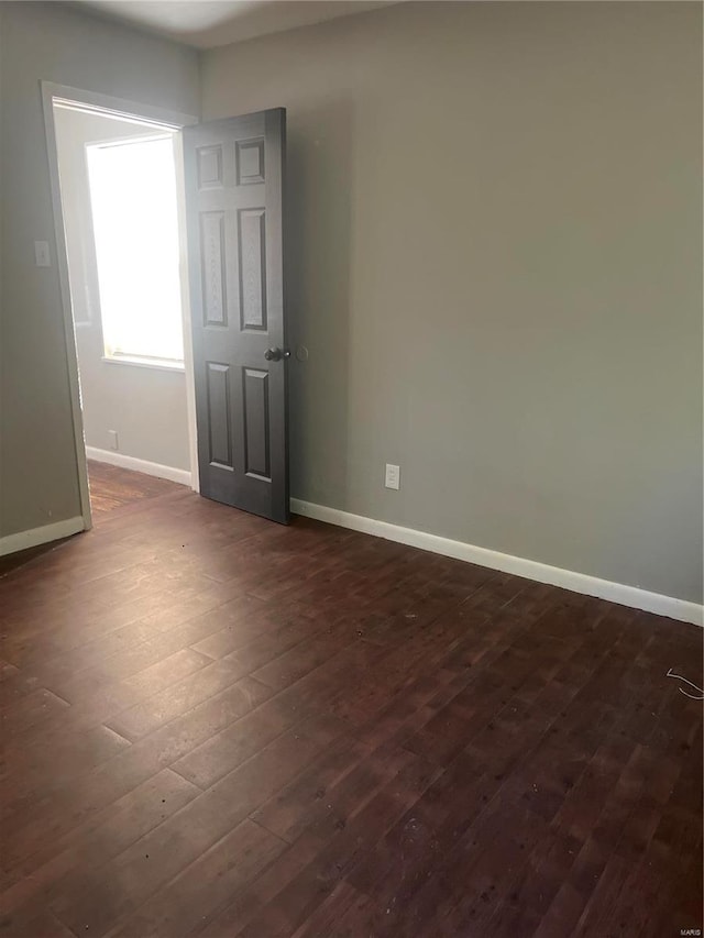 unfurnished room with dark hardwood / wood-style floors