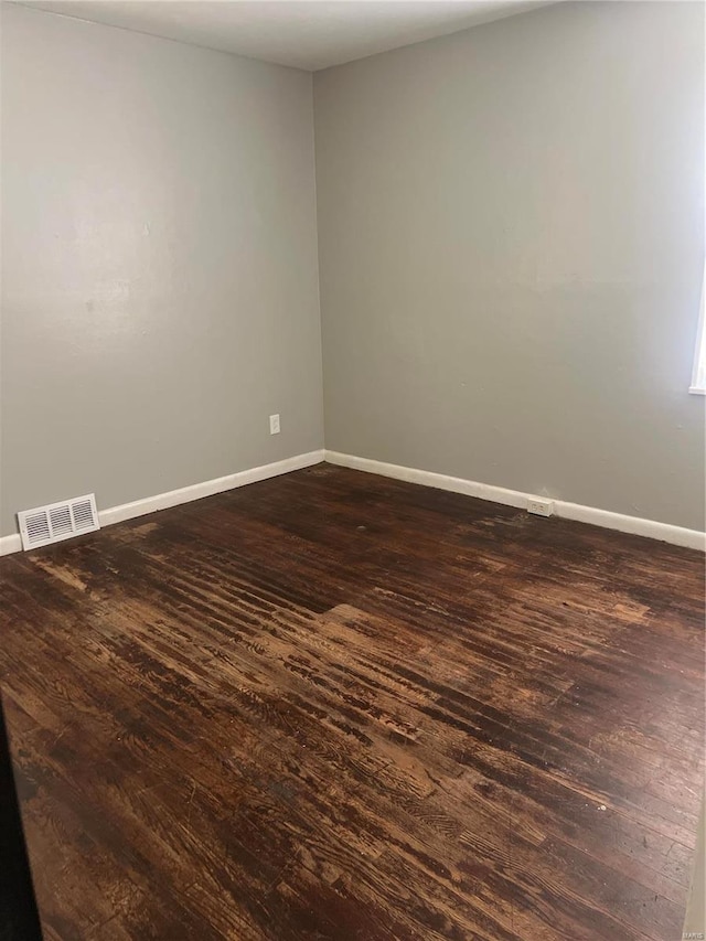 empty room with dark hardwood / wood-style floors