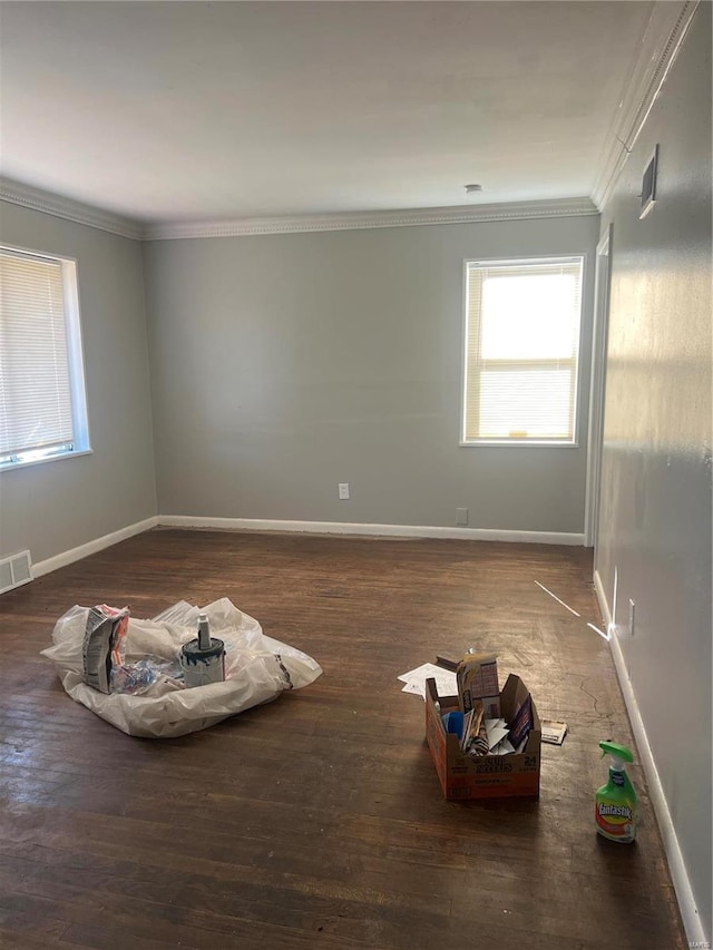 unfurnished room with crown molding and dark wood-type flooring