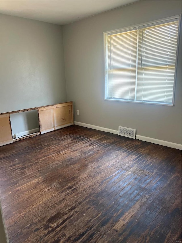 empty room featuring dark hardwood / wood-style flooring