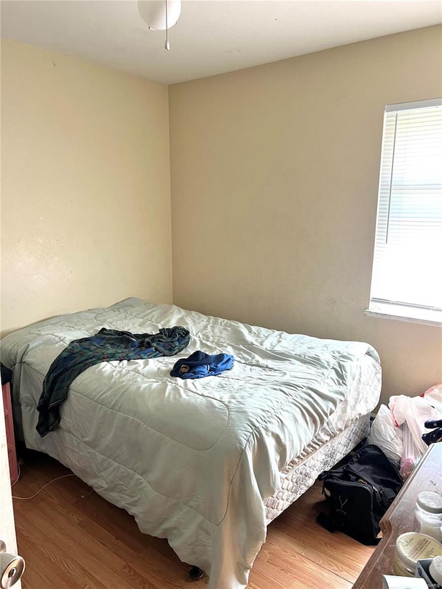 bedroom with wood-type flooring