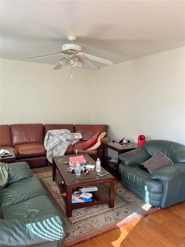 living room featuring wood-type flooring and ceiling fan