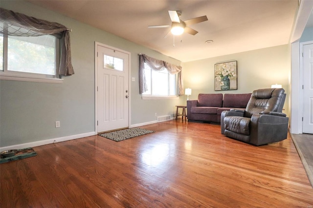 living room with hardwood / wood-style flooring and ceiling fan