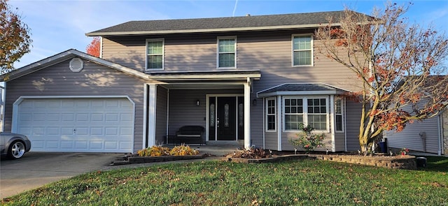 front facade with a garage and a front lawn