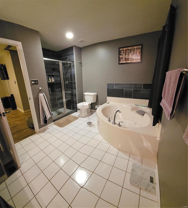 bathroom featuring separate shower and tub, toilet, and wood-type flooring