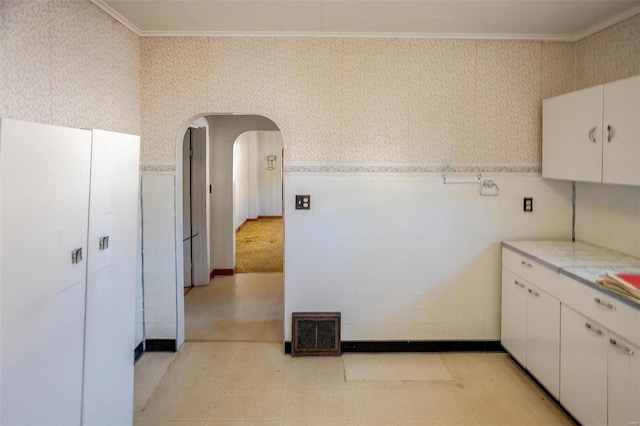 kitchen with white cabinetry and crown molding