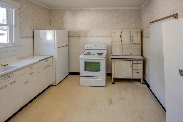 kitchen with white appliances and ornamental molding