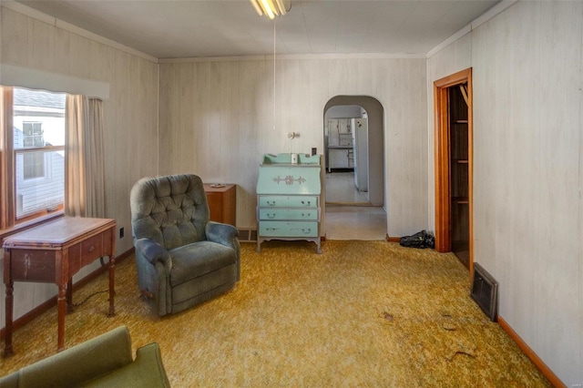 sitting room with carpet floors and ornamental molding