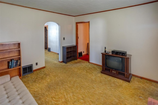 carpeted living room with ornamental molding