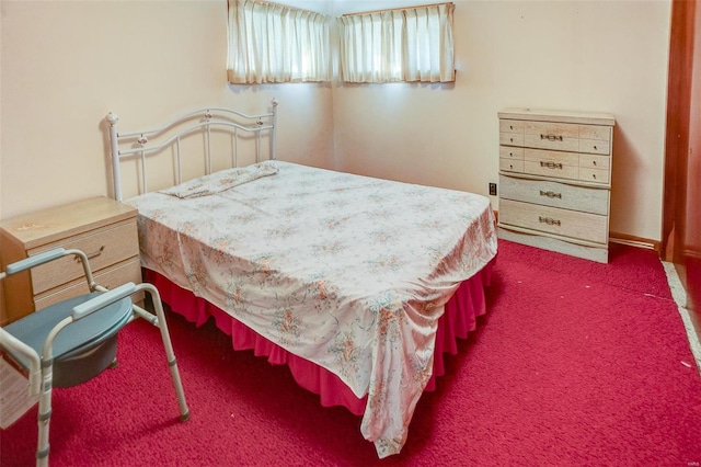 bedroom with dark colored carpet