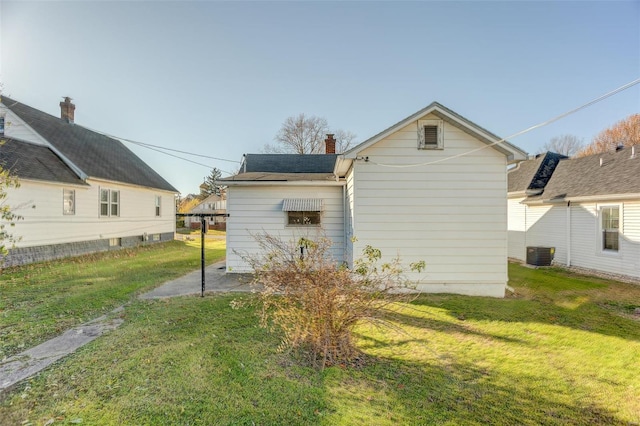 view of side of home featuring a yard and central air condition unit